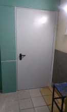 Противопожарная дверь белого цвета с выпадающим порогом